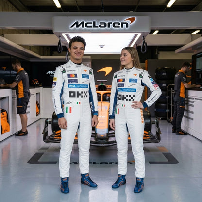 Man and woman in white and blue McLaren racing suits in the garage
